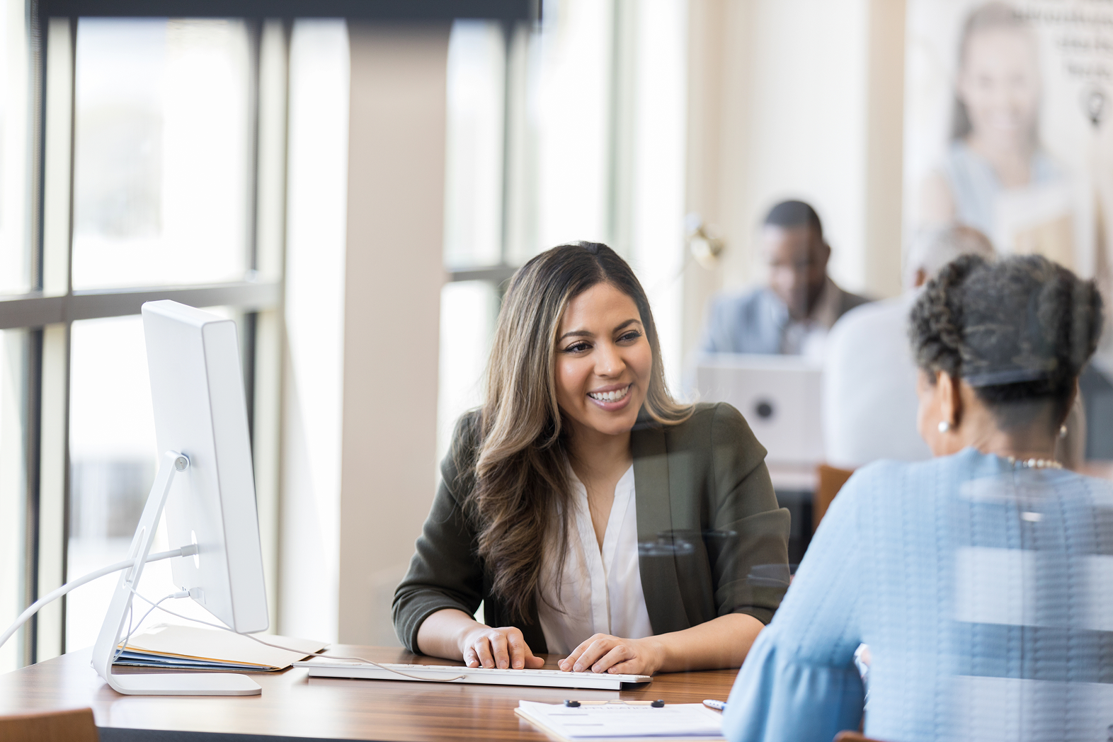 Woman working with Client at desk